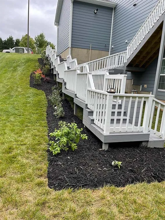 Deck railing with fresh landscaping
